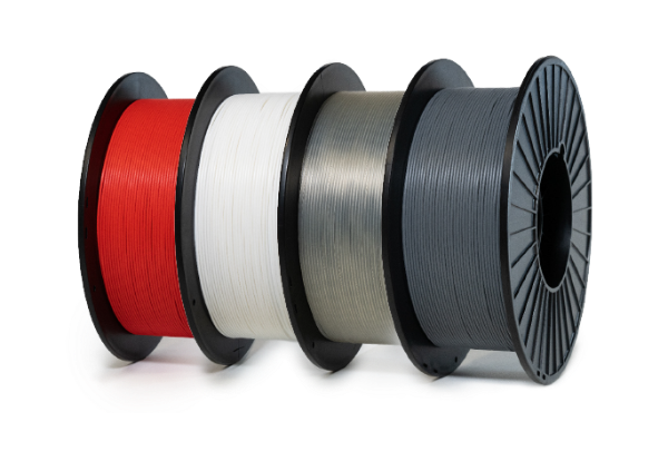 Spools of LumaFuse PLA 3100 additive filament in red, white, grey and black