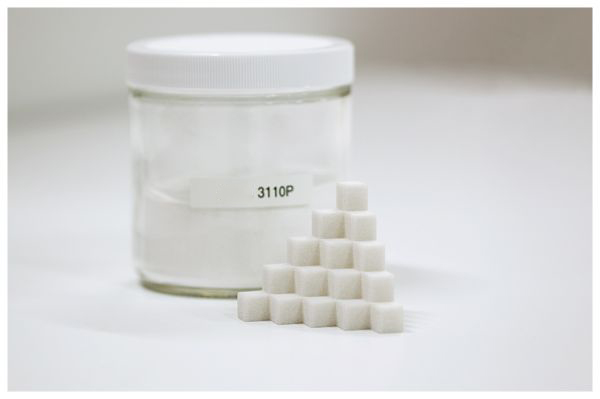 White LumaSint PLA 3110p additive powder in a glass jar